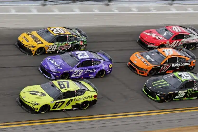 Feb 15, 2026; Daytona Beach, Florida, USA; Driver Corey Heim (67) pulls ahead of Driver Bubba Wallace (23) and Driver Christopher Bell (20) during the 68th running of the Daytona 500 at Daytona International Speedway.