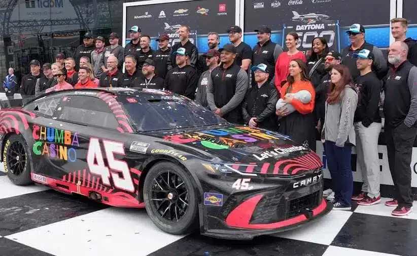 Hamlin; Daytona 500 winner Tyler Reddick, driver of the No. 45 23XI Racing Toyota, poses with his team during his champion ceremony in Victory Lane, Monday, Feb. 16, 2026.