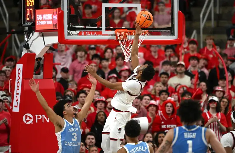 NC State Wolfpack guard Quadir Copeland (11) lays the ball up for a basket against the North Carolina Tar Heels during the first half.