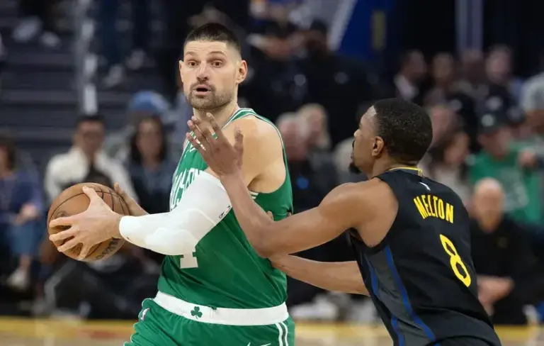 Boston Celtics center Nikola Vucevic (4) looks to pass around Golden State Warriors guard De'Anthony Melton (8) during the first quarter.