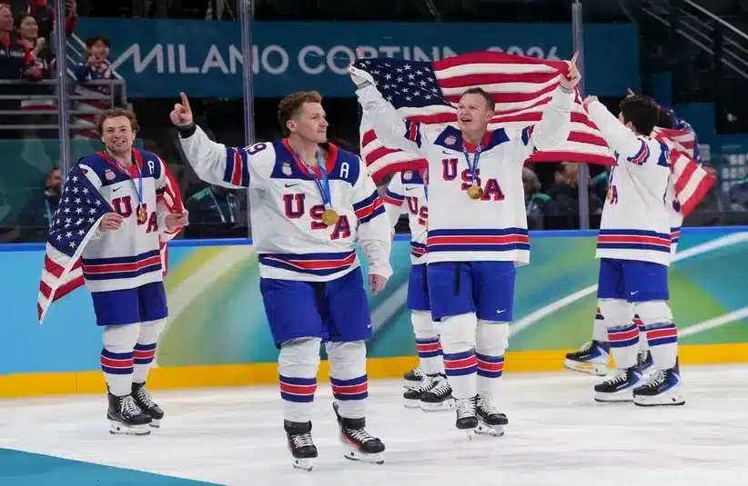 United States players including Brady Tkachuk (7) of the United States celebrate after defeating Canada in the men's ice hockey gold medal game during the Milano Cortina 2026 Olympic Winter Games