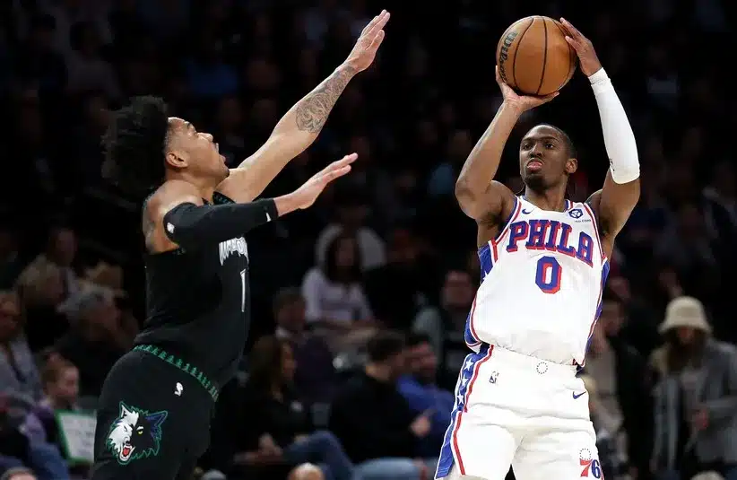 Philadelphia 76ers guard Tyrese Maxey (0) shoots over Minnesota Timberwolves guard Terrence Shannon Jr. (1)