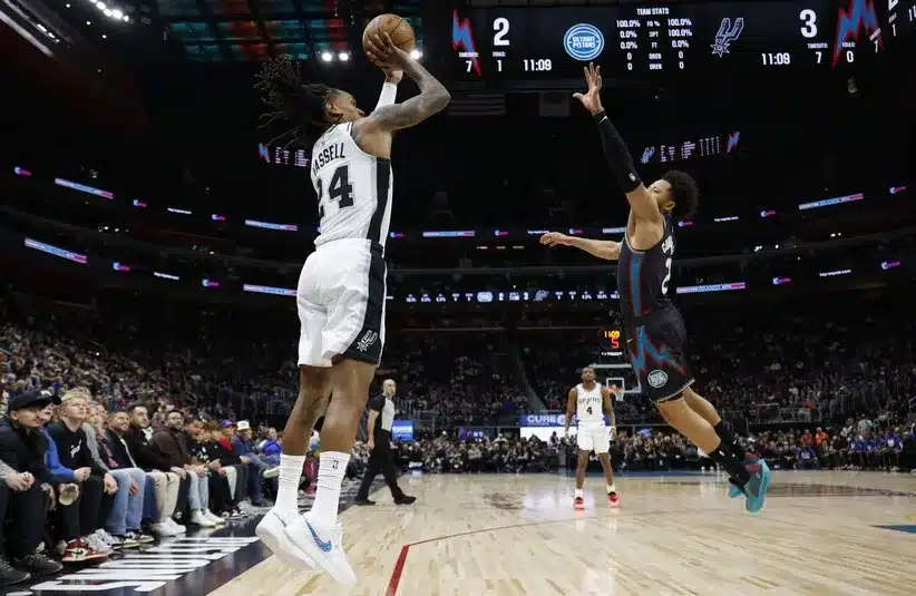 San Antonio Spurs guard Devin Vassell (24) shoots on Detroit Pistons guard Cade Cunningham (2)