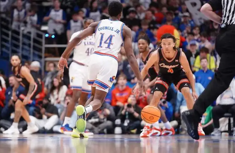 Kansas Jayhawks guard Melvin Council Jr. (14) dribbles down court against Houston Cougars during the game.