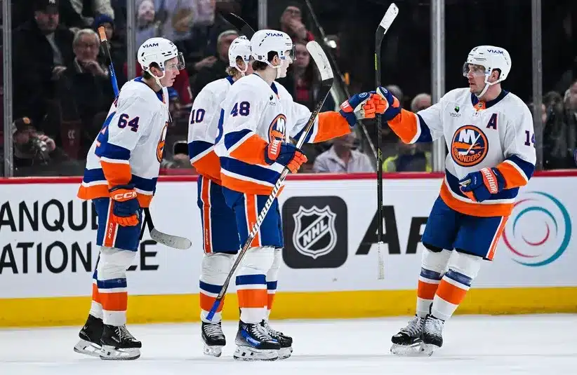 New York Islanders defenseman Matthew Schaefer (48) celebrates with his teammates his first goal of the game against the Montreal Canadiens. Schaefer is a key to Matthieu Darche's success.