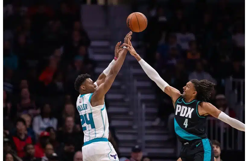 Charlotte Hornets forward Brandon Miller shoots the ball over Portland Trail Blazers guard Matisse Thybulle