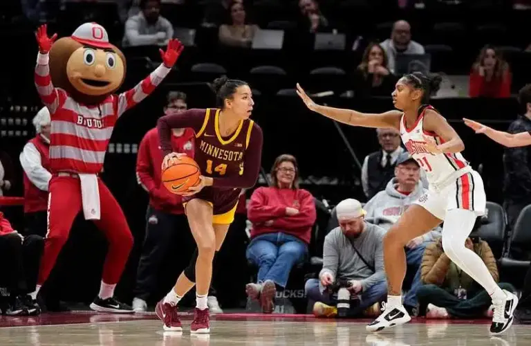 Ohio State Buckeyes guard Chance Gray (21) defends Minnesota Golden Gophers guard Tori McKinney (14) with sideline help from mascot Brutus during the first half of the NCAA women's basketball game at Value City Arena in Columbus on Feb. 13, 2025.