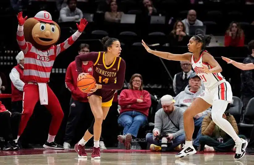 Ohio State Buckeyes guard Chance Gray (21) defends Minnesota Golden Gophers guard Tori McKinney (14) with sideline help from mascot Brutus during the first half of the NCAA women's basketball game at Value City Arena in Columbus on Feb. 13, 2025.