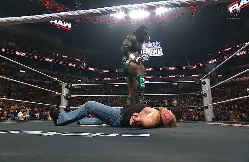 Obi Femi standing over Brock Lesnar on Raw.