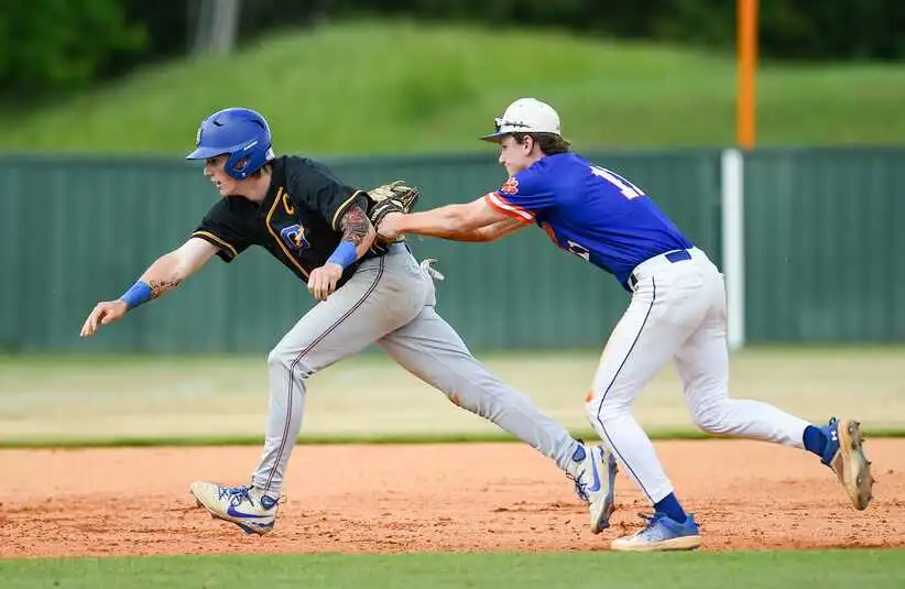 Oxford Chargers' James Blackwood (9) is tagged out by Madison Central Jaguars' Ryan Delaney (11) after getting caught in a rundown during the 2025 MHSAA Class 7A baseball state playoffs game in Madison, Miss., on Saturday, May 3, 2025.