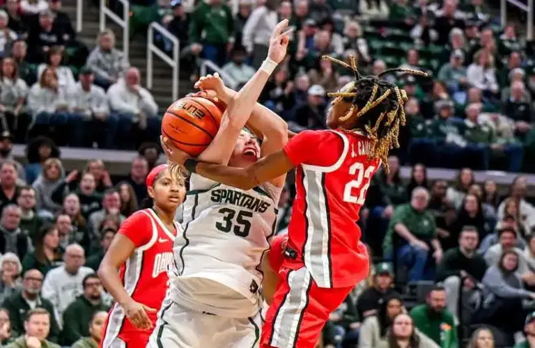 Michigan State's Kennedy Blair, left, is fouled by Ohio State's Jaloni Cambridge while shooting during the fourth quarter on Sunday, March 1, 2026, at the Breslin Center in East Lansing.