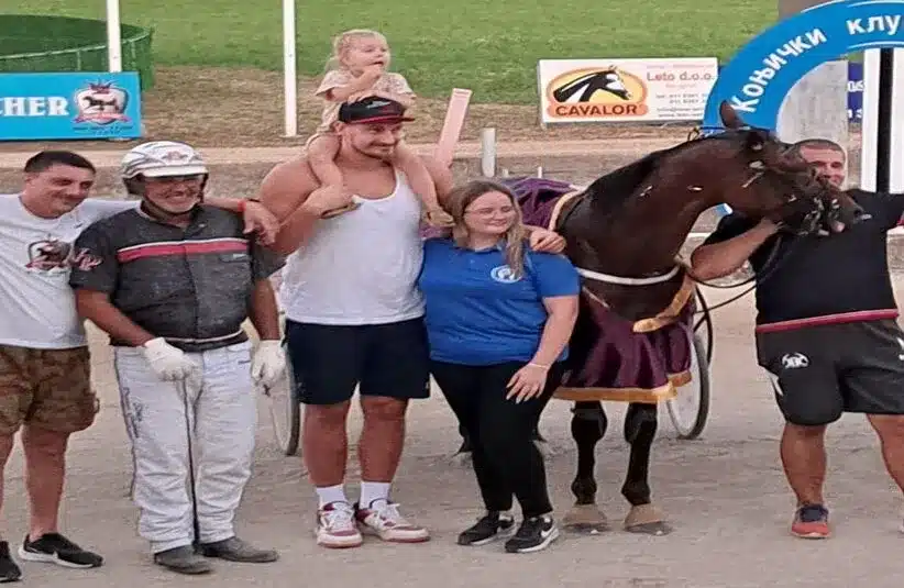 Nikola Jokic taking a photo next to his horse Brenno Laumar after winning a horsing race