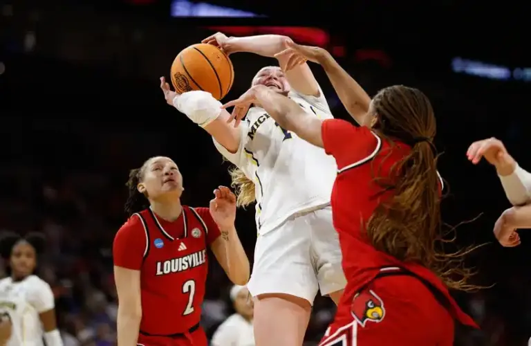 Michigan Wolverines guard Olivia Olson (1) drives to the basket between Louisville Cardinals guard Imari Berry (2) and forward MacKenly Randolph (4) during the second half at Dickies Arena.
