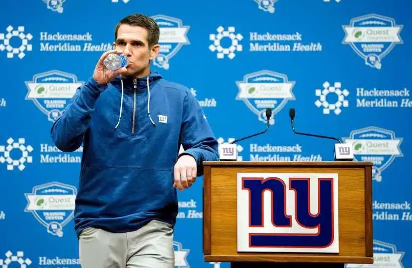 New York Giants general manager Joe Schoen takes a drink of water before the pre-draft press conference