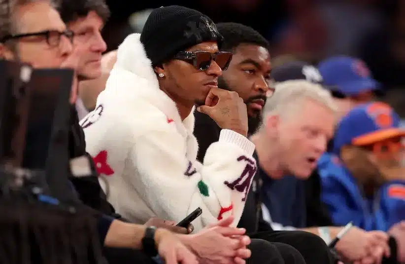 Manchester United player Marcus Rashford sits court side