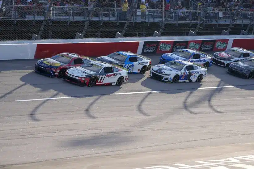 Aug 31, 2025; Darlington, South Carolina, USA; NASCAR Cup Series driver Chase Briscoe (19) and driver Denny Hamlin (11) lead the field to the start during the Cookouts Southern 500 at Darlington Raceway.