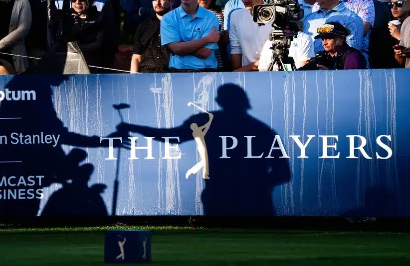 Rickie Fowler hands his putter to his caddy Ricky Romano on the tenth hole during the second round of the Players Championship