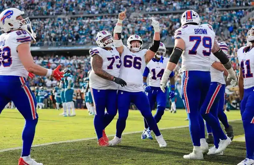 Connor McGovern (66) of the Buffalo Bills celebrates a touchdown by Josh Allen during an AFC Wild Card playoff game against the Jacksonville Jaguars. Buffalo won 27-24.