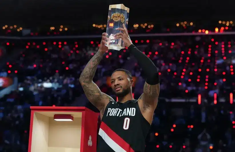 Portland Trail Blazers guard Damian Lillard (0) holds the trophy after winning the three point contest