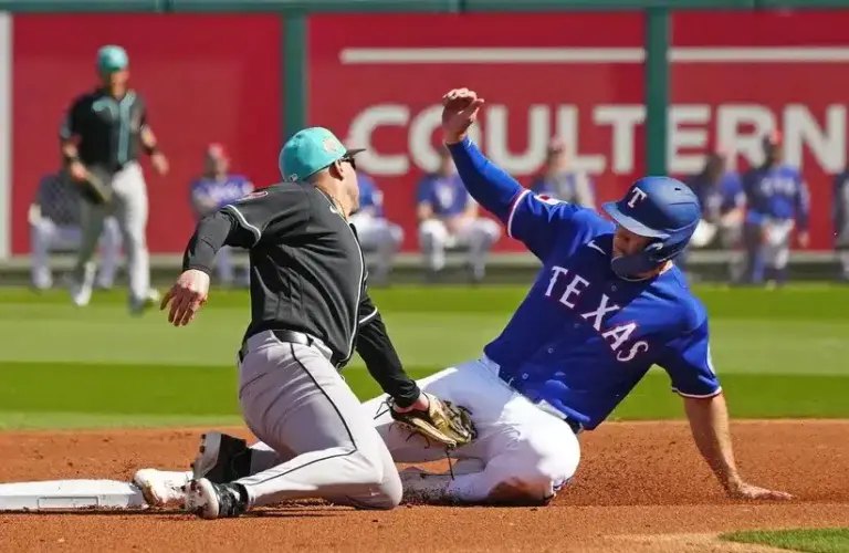 Rangers outfielder Wyatt Langford (61) slides safely into second base