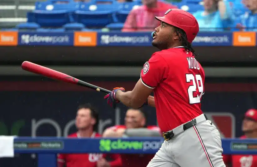 Washington Nationals left fielder James Wood hits a ball in a game against New York Mets