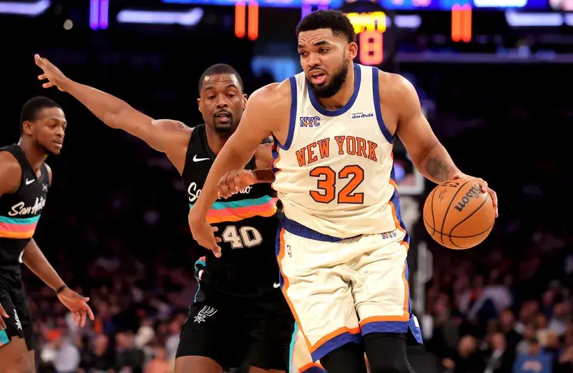 New York Knicks center Karl-Anthony Towns (32) controls the ball against San Antonio Spurs forward Harrison Barnes (40) during the second quarter.