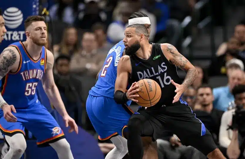 Dallas Mavericks forward Caleb Martin (16) looks to move the ball