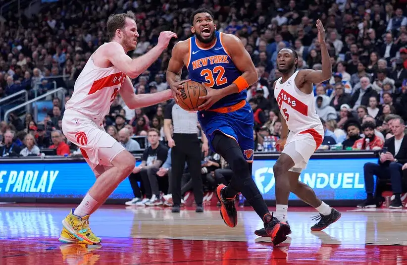 New York Knicks center Karl-Anthony Towns (32) drives to the basket against Toronto Raptors center Jakob Poeltl (19) during the first half.