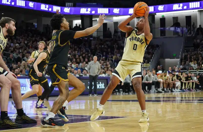 Purdue guard CJ Cox puts a shot up against Northwestern.