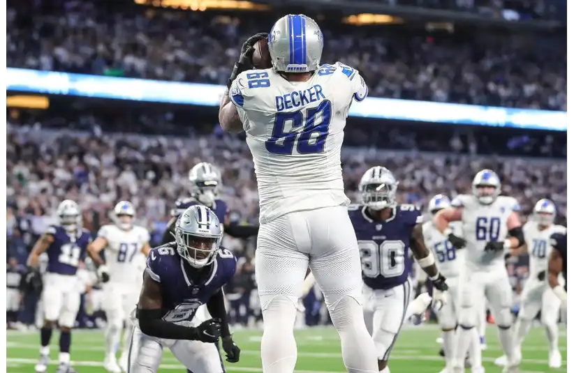 Taylor Decker leaping on the football field