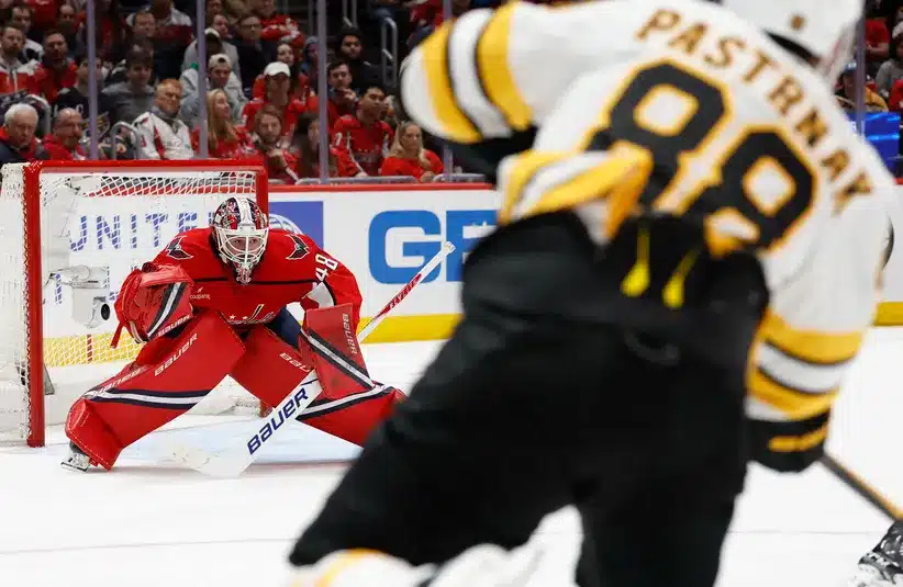 Logan Thompson making a save in the Washington Capitals' Boston Bruins game in 3-2 loss in shootout