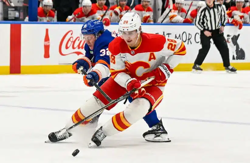 Calgary Flames defenseman Zach Whitecloud (28) skates with the puck
