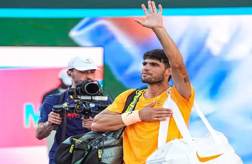 Alcaraz waving to the fans