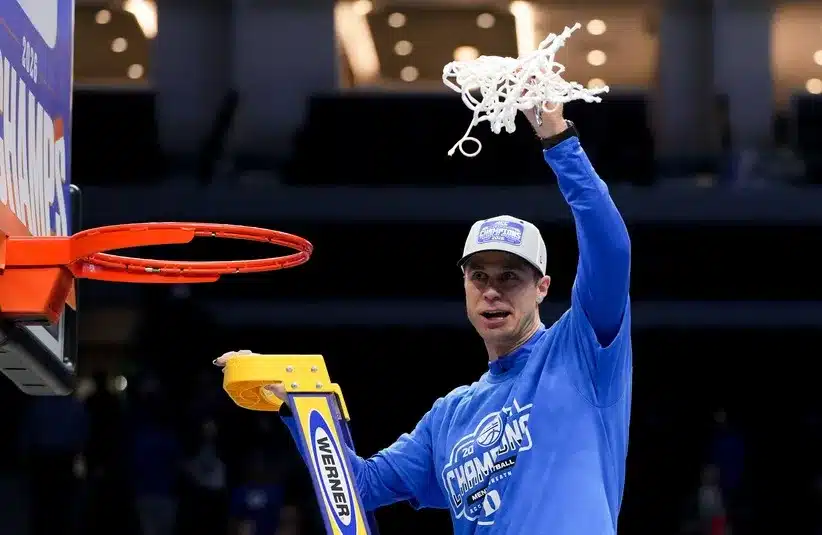 Duke Blue Devils head coach Jon Scheyer cuts down the net