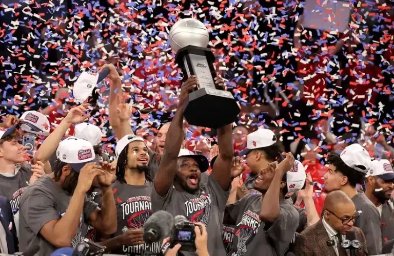St. John's Red Storm players celebrate after defeating the Connecticut Huskies