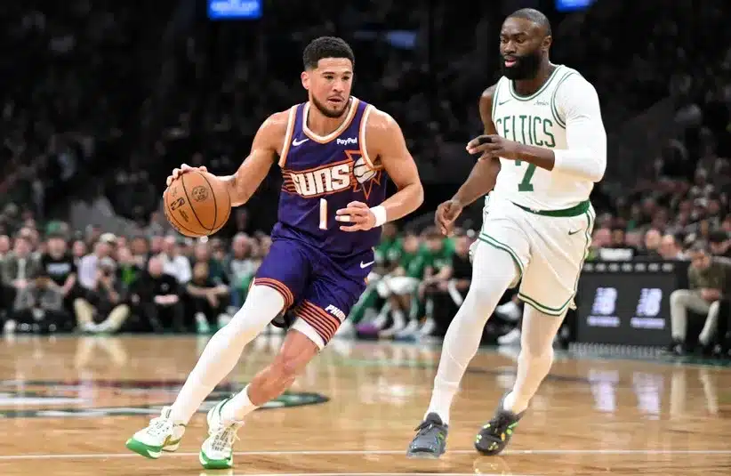 Phoenix Suns guard Devin Booker (1) drives to the basket against Boston Celtics guard Jaylen Brown (7)