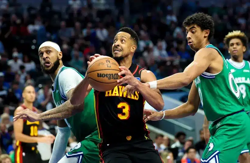 Atlanta Hawks guard CJ McCollum (3) shoots as Dallas Mavericks forward Daniel Gafford (21) and Dallas Mavericks guard Max Christie (00) defend