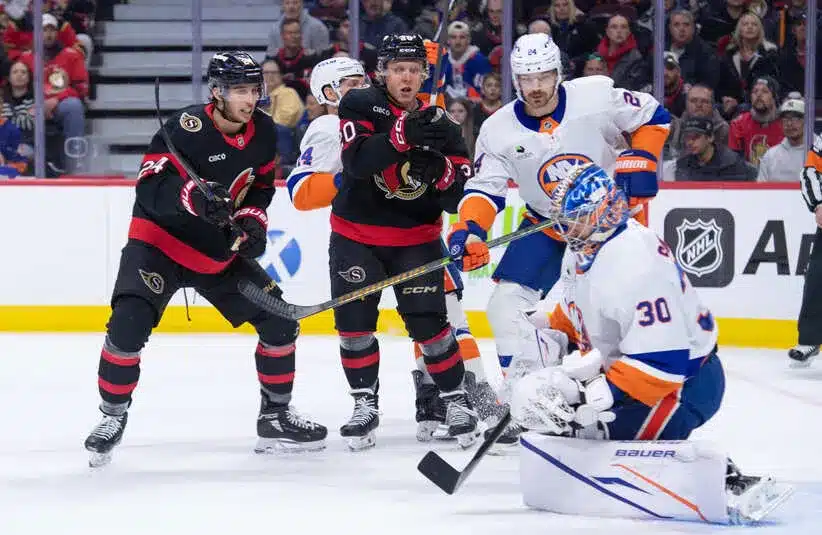 New York Islanders goalie Ilya Sorokin (30) makes a save in front of Ottawa Senators center Dylan Cozens (24