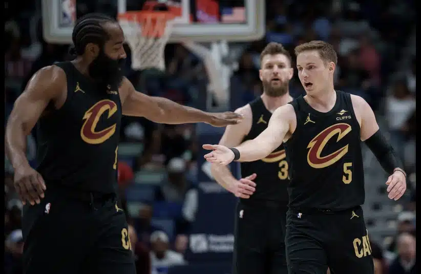 Cavaliers guard James Harden (1) celebrates with Cleveland Cavaliers guard Sam Merrill (5) during the first half against the New Orleans
