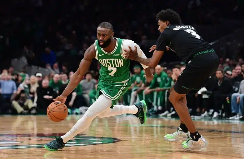 Boston Celtics guard Jaylen Brown (7) controls the ball against the Timberwolves.