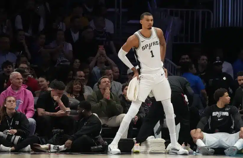 San Antonio Spurs forward Victor Wembanyama (1) stretches before coming back into the game.