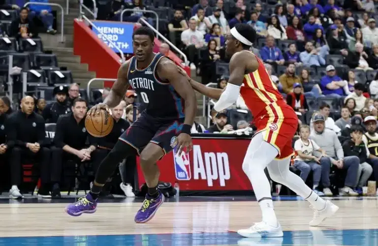 Detroit Pistons center Jalen Duren (0) dribbles defended by Atlanta Hawks forward Onyeka Okongwu (17)