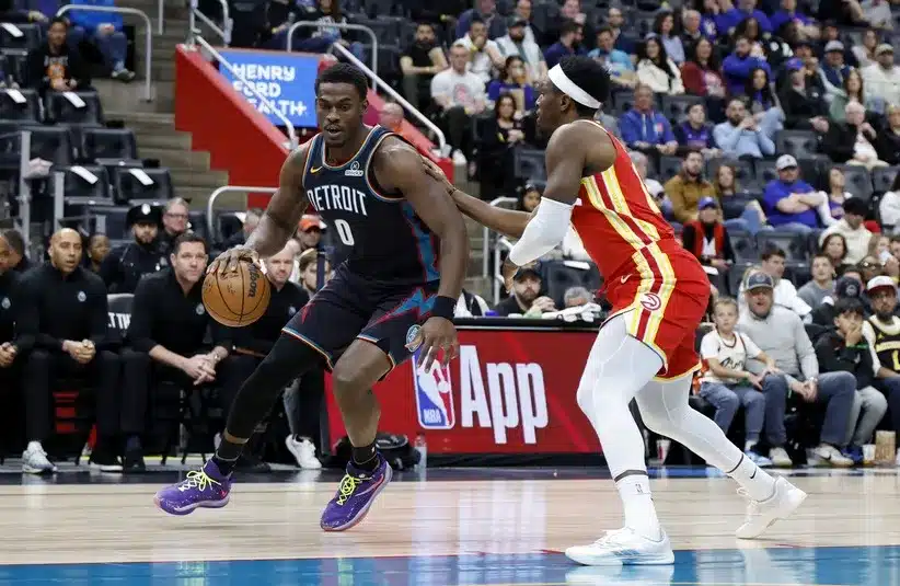 Detroit Pistons center Jalen Duren (0) dribbles defended by Atlanta Hawks forward Onyeka Okongwu (17)