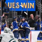 Blues on the ice celebrating the overtime winning goal