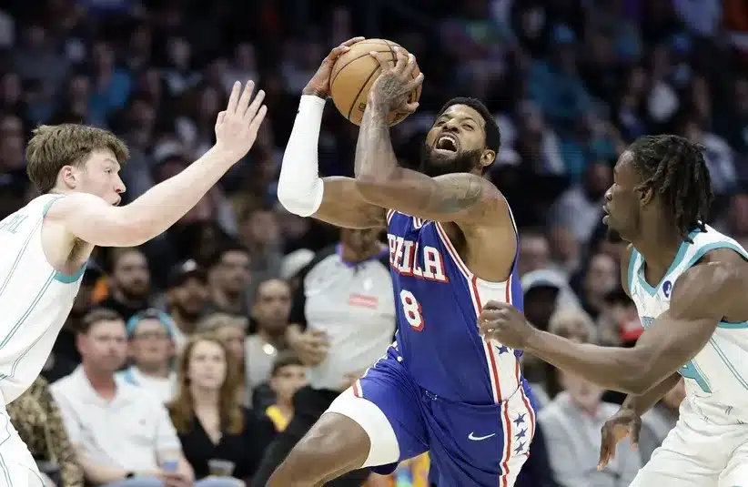 Philadelphia 76ers forward Paul George (8) tries to drive.