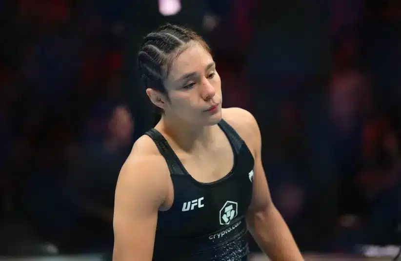 Alexa Grasso (red gloves) waits for Maycee Barber (blue gloves) to be examined by medical staff.