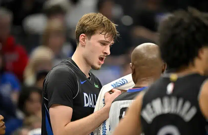 Dallas Mavericks forward Cooper Flagg (32) holds a towel on his face