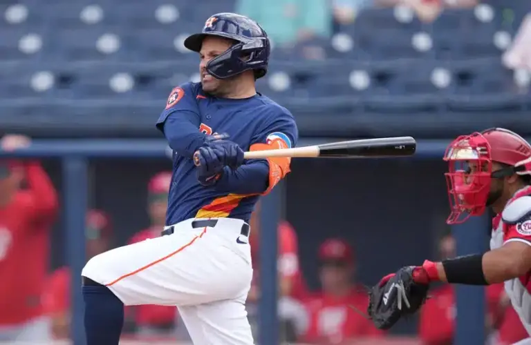 Mar 2, 2026; West Palm Beach, Florida, USA; Houston Astros left fielder Jose Altuve (27) hits a single in the first inning against the Washington Nationals at CACTI Park of the Palm Beaches.
