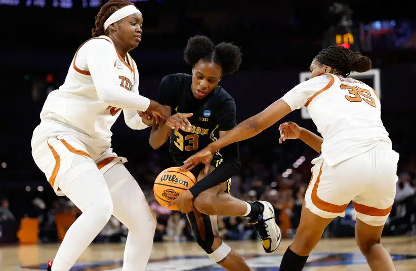 Mar 30, 2026; Fort Worth, TX, USA; Michigan Wolverines guard Te'yala Delfosse (33) is fouled by Texas Longhorns forward Madison Booker (35) during the second half at Dickies Arena.