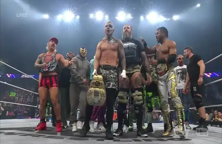 Darby Allin celebrating with the AEW locker room after beating MJF.